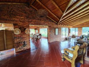 a large room with a brick wall and wooden ceilings at La Toscana, Chalet Campestre in Guasca +21 photos