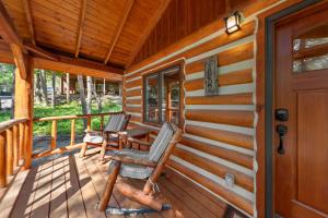 two chairs sitting on the porch of a cabin at Moose Hollow Studio Cabin in Eureka