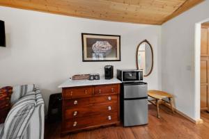 a kitchen with a dresser with a microwave on it at Moose Hollow Studio Cabin in Eureka