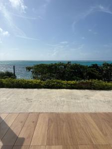 a wooden floor with a view of the ocean at Ocean Inn- Sector el Bluff in Bottom House