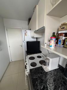 a small kitchen with a stove and a refrigerator at Luxury in Villa Carlos Paz +4 photos