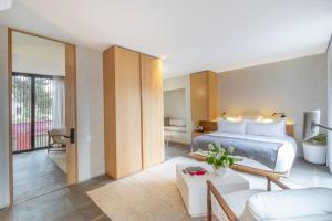 a bedroom with a bed and a living room at Octavia Casa in Mexico City