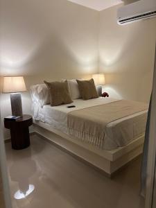 a bedroom with a bed with two lamps on it at Ocean Inn- Sector el Bluff in Bottom House +39 photos