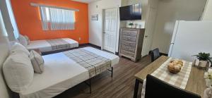 a small room with two beds and a table at Siegel Select Orange Park in Orange Park