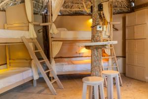 a room with two bunk beds and two stools at Treehouse Kitecamp Jericoacoara in Jericoacoara