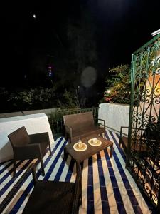 a patio with a table and chairs on a deck at Cosy 1BD Pool, Beach, Large Terrace in Hammam Sousse