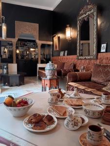 a table with plates of food on top of it at Riad Dar Badiaa in Salé