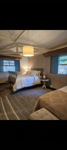 a large bedroom with two beds and a lamp at Chateau Tiradentes in Tiradentes