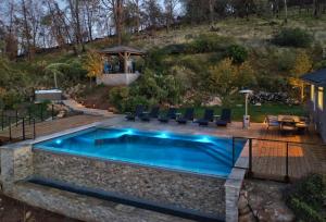 a swimming pool in a yard with chairs around it at Vineyard Setting With 180 Panoramic Lake Views in Lower Lake +21 photos