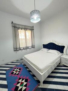 a bedroom with a bed and a chandelier at Marina Escape, 2BD, Pool and Beach in Hammam Sousse