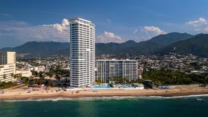 a view of a beach and a tall building at Gorgeous 1BR Condo with Pools & Sea Views in Puerto Vallarta