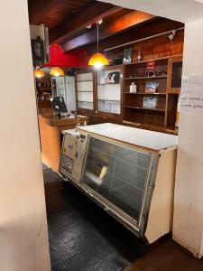 a kitchen with an oven in the middle at Refugio Pehuenche in Los Molles +6 photos