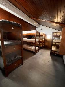 a room with several bunk beds in a house at Refugio Pehuenche in Los Molles