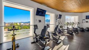 a gym with several treadmills and elliptical machines at Gorgeous 1BR Condo with Pools & Sea Views in Puerto Vallarta