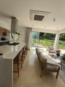 a kitchen with a table and chairs and a large window at Sol del Este Luxury by SH in San Andrés