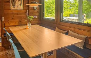 a wooden table and chairs in a room at Cozy Home In Ebeltoft With Wifi in Ebeltoft