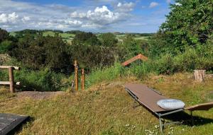a chair sitting in the grass in a field at Cozy Home In Ebeltoft With Wifi in Ebeltoft +19 photos