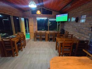 a empty restaurant with wooden tables and chairs at Sigchos Lodge in Sigchos