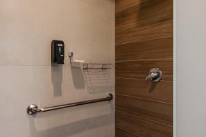a bathroom with a door with a phone on the wall at Pousada Calza - Vale dos Vinhedos - Bento Gonçalves in Bento Gonçalves +99 photos