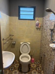 a bathroom with a toilet and a sink at Sri impiana in Pantai Cenang +45 photos