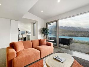 a living room with a couch and a piano at Epic Views and Deck | Spacious Queenstown Home in Queenstown