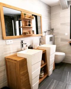 a bathroom with two sinks and a toilet at Villa Champlan in Champlan +4 photos
