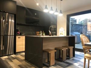 a kitchen with a counter and a refrigerator at Villa Champlan in Champlan