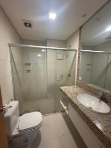 a bathroom with a shower and a toilet and a sink at Intercity - Apartmento 412 in Manaus +6 photos