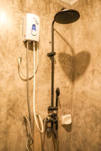 a shower in a bathroom with a shower head at Kabilin Homestay in General Luna