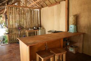 a kitchen with a counter and stools in a room at Kabilin Homestay in General Luna +28 photos