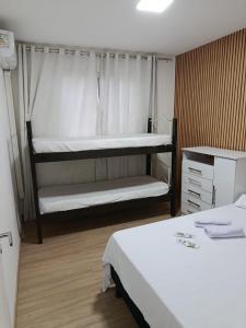 a bedroom with two beds and a bunk bed at Lar Luar do Sertão in Aracaju +30 photos