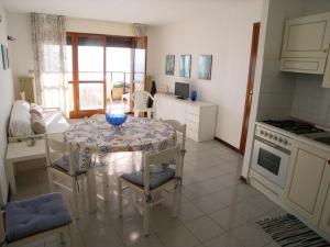 a kitchen and dining room with a table and chairs at Villa Matilde in Grado +20 photos