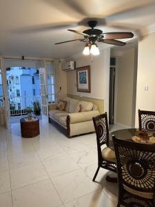 a living room with a couch and a ceiling fan at Seaside Escape in Montego Bay