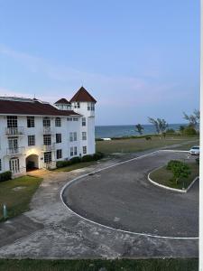 a large white building next to the ocean at Seaside Escape in Montego Bay