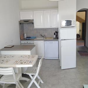 CasaglioneにあるPanoramic Seaview studio Tiucciaのキッチン(白いキャビネット、白い冷蔵庫付)