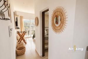 a hallway with a mirror on the wall and a room at Suites Amplias y Comfortables - Con Balcon, Parquizado, Asador y Pileta in Tafí del Valle