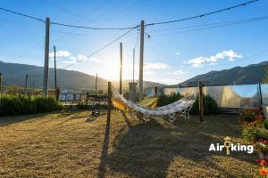 a hammock in a yard with mountains in the background at Suites Amplias y Comfortables - Con Balcon, Parquizado, Asador y Pileta in Tafí del Valle