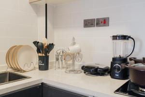 a kitchen counter with utensils and a blender at Everlett Lavington Homes in Nairobi +3 photos