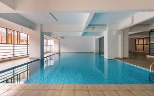a pool with blue water in a building at Everlett Lavington Homes in Nairobi
