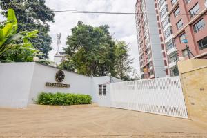 a white fence in front of a building at Everlett Lavington Homes in Nairobi