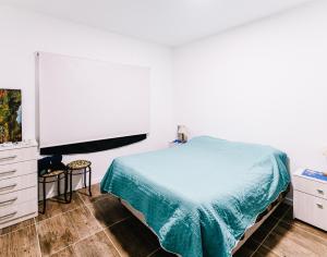 a bedroom with a bed and a dresser and a tv at Casa Las Dunas in Monte Hermoso