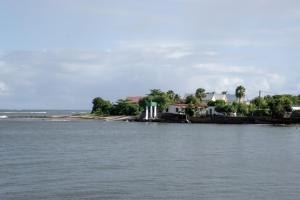a large body of water with houses and trees at Escale moulienne in Le Moule