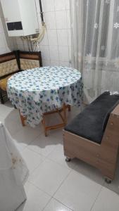 a room with a table and two beds in it at Huzur 30 in Edirne +1 photo