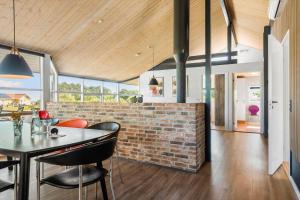 a kitchen and dining room with a brick wall at 8585-Glesborg-Tangvej-33 in Glesborg +18 photos