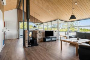 a living room with a couch and a fireplace at 8585-Glesborg-Tangvej-33 in Glesborg