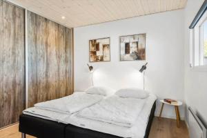 a bed in a room with white walls at 8585-Glesborg-Tangvej-33 in Glesborg