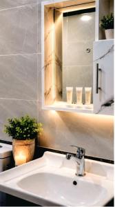 a white sink in a bathroom with a mirror at Wadi Rum Elara Luxury Camp in Wadi Rum