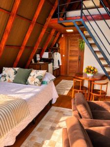a living room with a bed and a table at Cabana Fé in Nonoai +38 photos