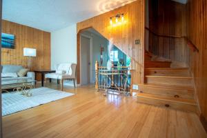 a living room with a staircase in a house at Refuge urbain du Trait-Carré in Laval +8 photos