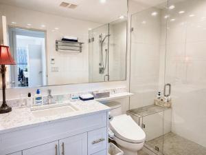 a bathroom with a toilet and a sink and a shower at Oceanfront Escape with Private Bath and Beach Access in Gibsons
